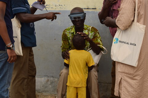 A young boy's eyes are examined for signs of trachoma during a Tropical Data training in Senegal.   Photo Credit: RTI International/Shea Flynn